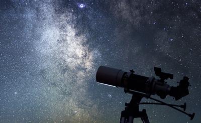 Telescope pointed towards starry sky