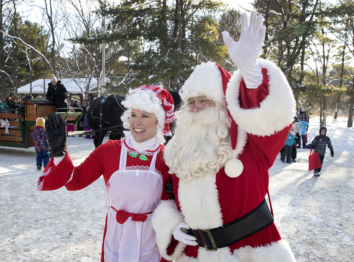 Santa and Mrs. Claus waving to children at Christmas at Ken Reid